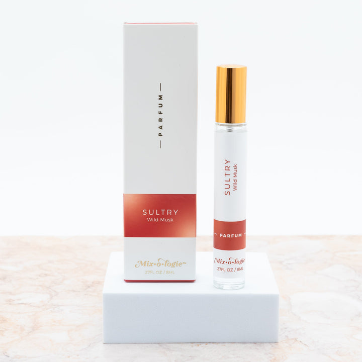 Mixologie Parfum in Sultry Wild Musk, 0.27 fl oz, clear glass roller bottle with gold cap and deep red box
