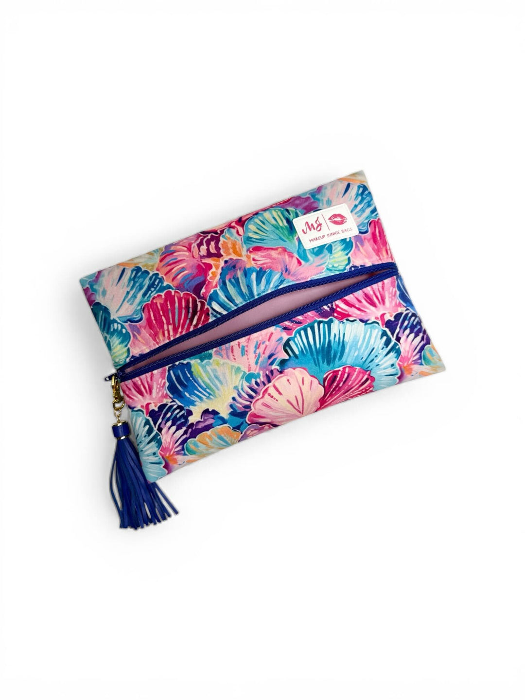 Makeup Junkie Bags large zip clutch in colorful seashell print with navy zipper and navy tassel on white background