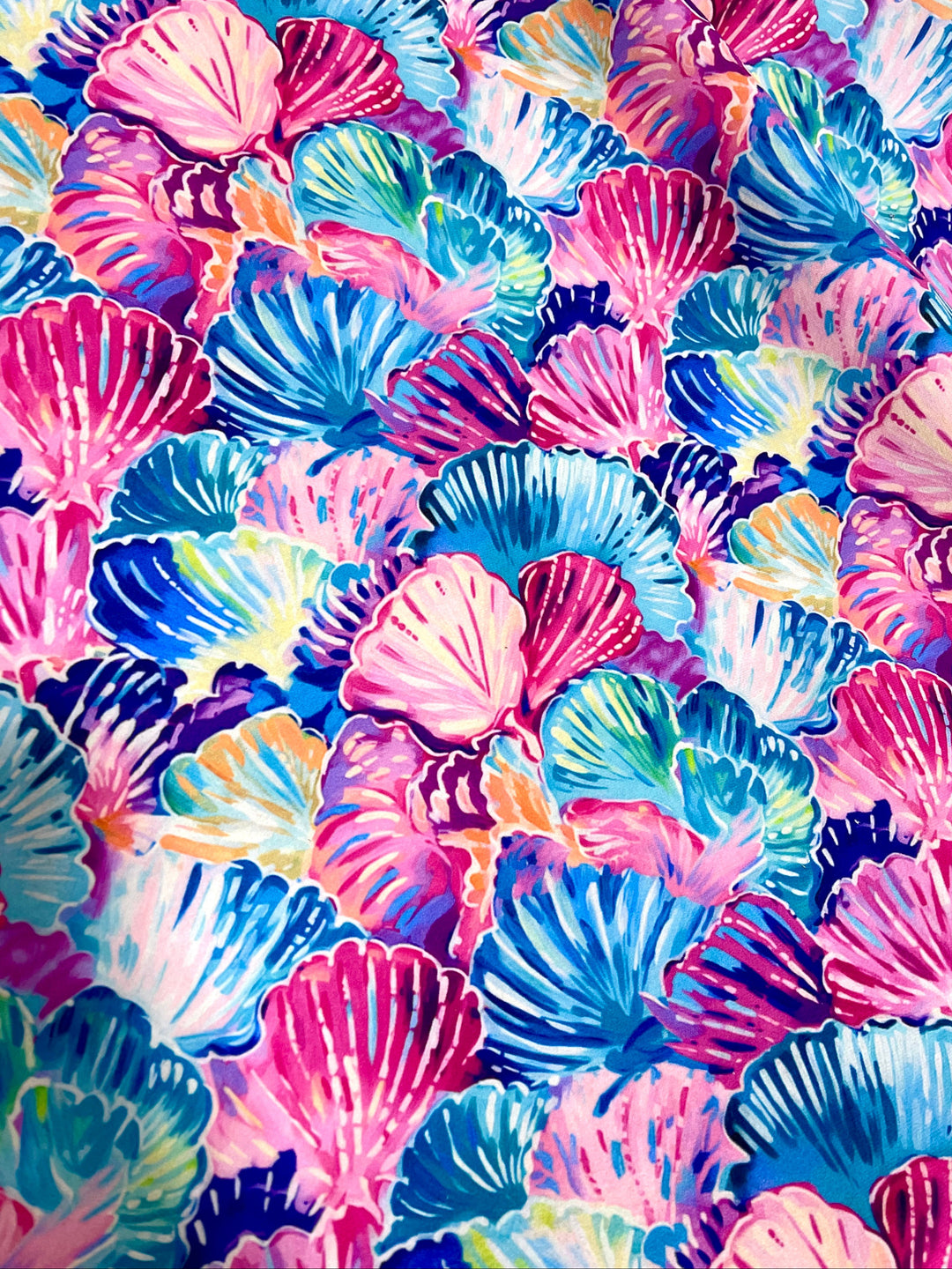 Colorful watercolor seashell print fabric in pink, blue, teal, purple, and orange used for Makeup Junkie Bags