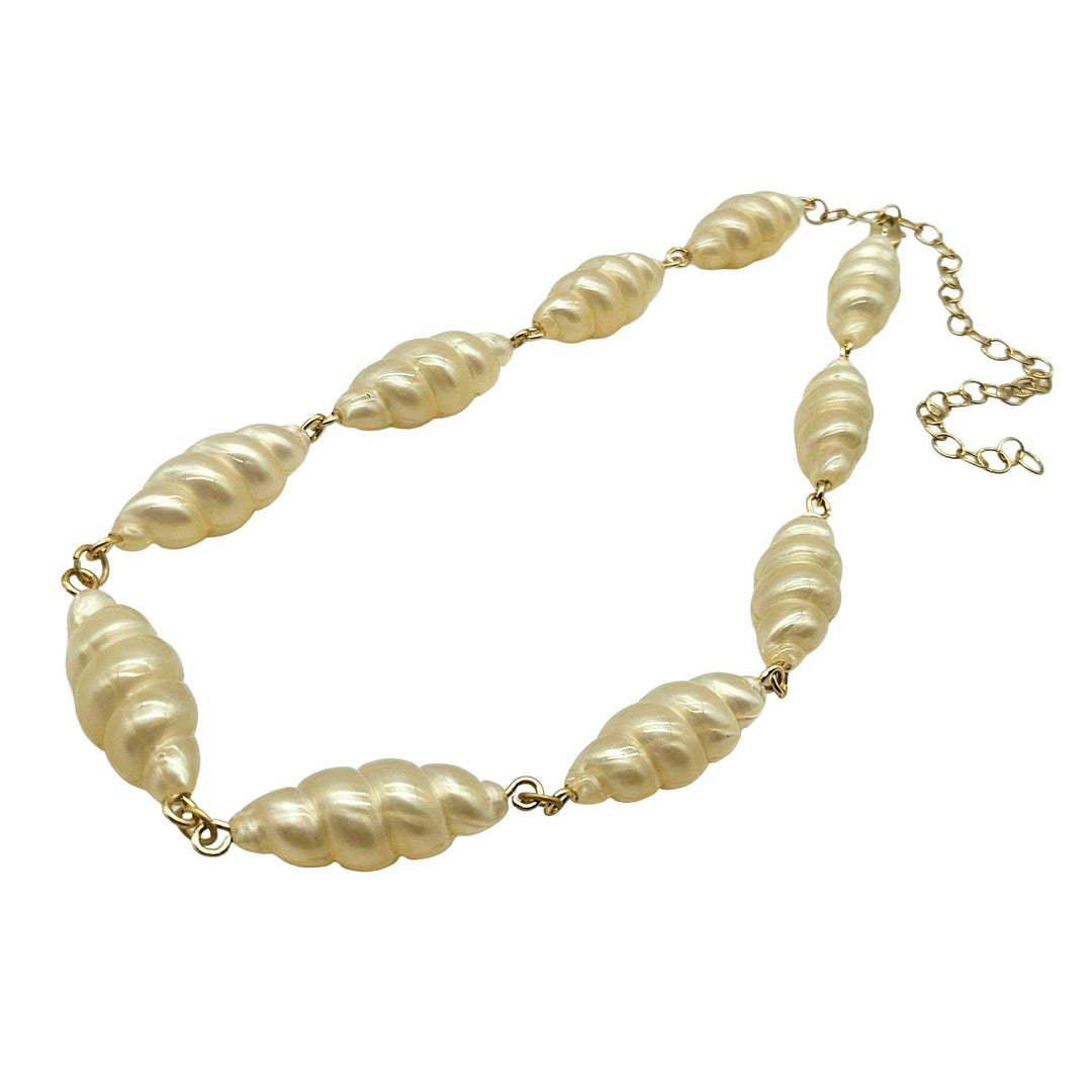Lucite pearl necklace with gold chain on a white background