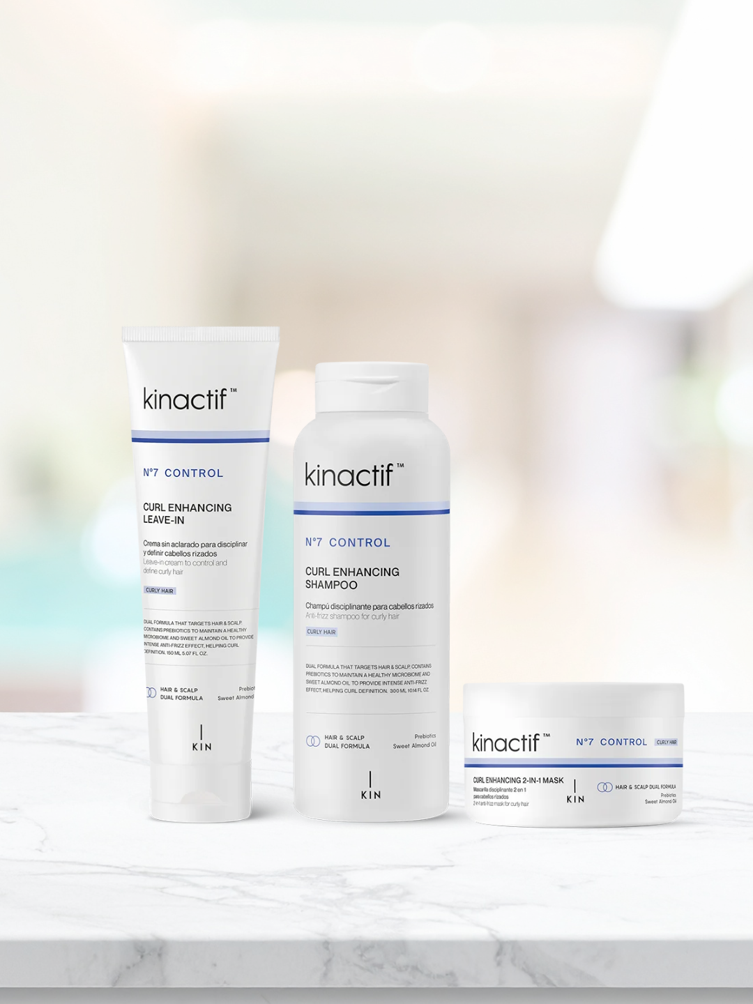 Kinactif N°7 Control curl enhancing leave-in, shampoo, and 2-in-1 mask set on marble surface with soft white background