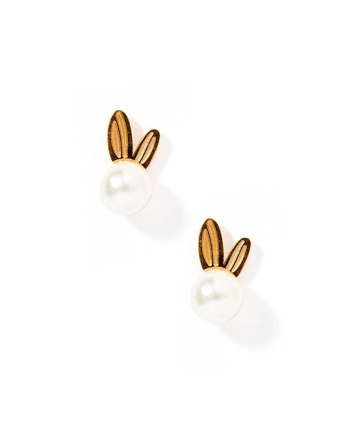 Gold bunny ear and white pearl stud earring pair flat lay on white background showing engraved ear detail.