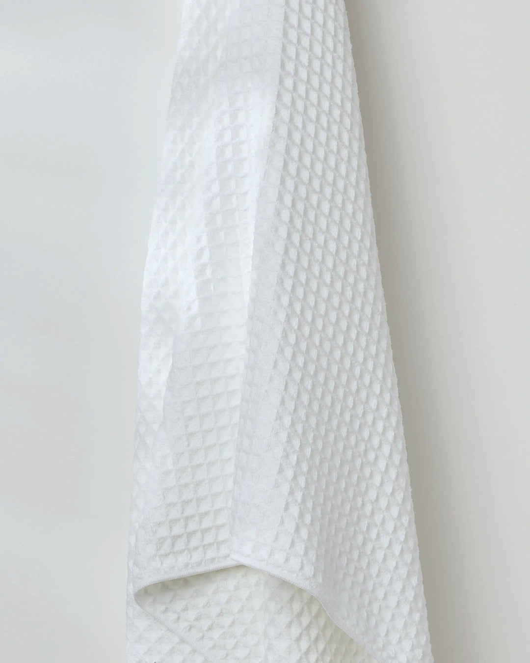 Close-up of white Cloud Waffle Bath Towel by Geometry showing waffle texture detail