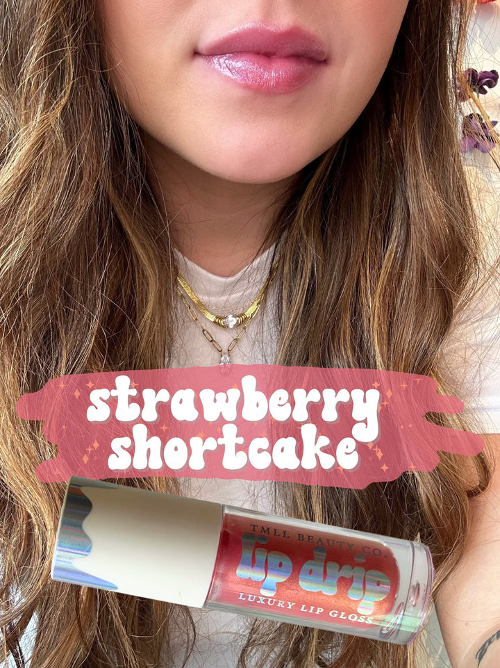 TMLL Beauty Co. Lip Drip Luxury Lip Gloss in Strawberry Shortcake — a sheer rosy pink shade shown on lips with tube below