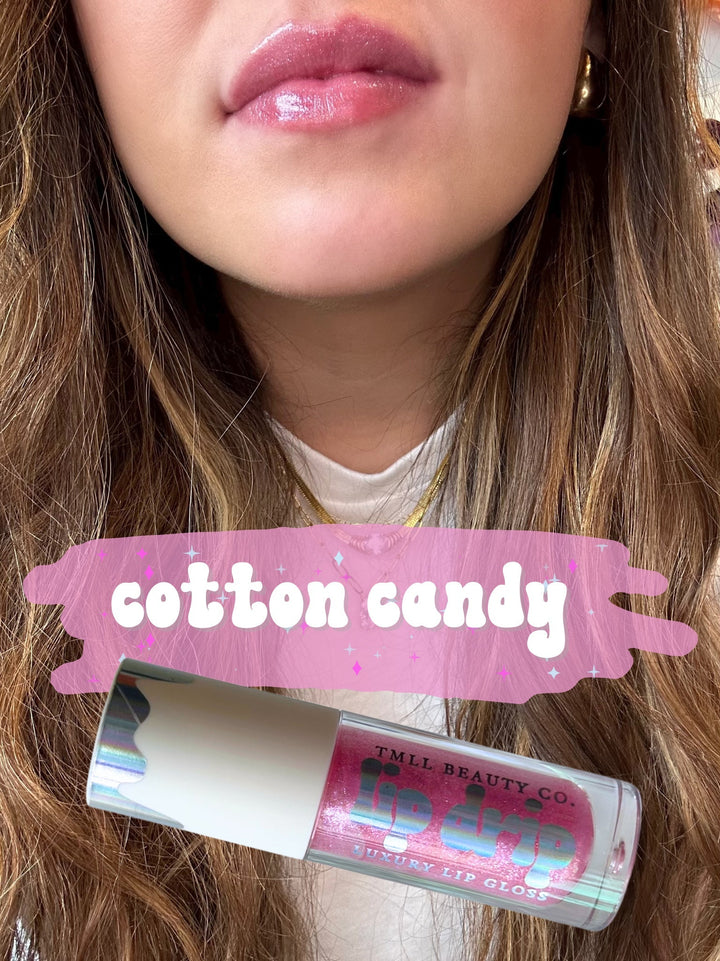 TMLL Beauty Co. Lip Drip Luxury Lip Gloss in Cotton Candy — a sheer pink glitter shade shown on lips with tube below