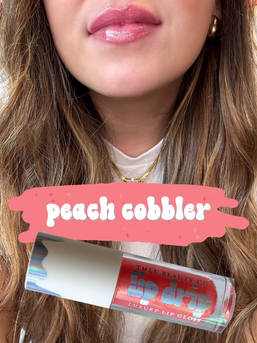 TMLL Beauty Co. Lip Drip Luxury Lip Gloss in Peach Cobbler — a sheer peachy-pink shimmer shade shown on lips with holographic tube below