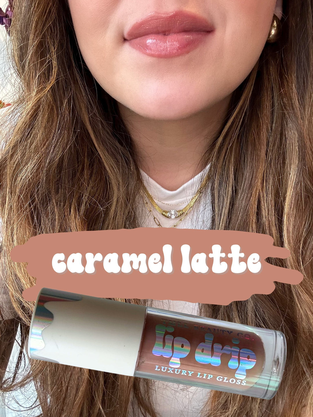 TMLL Beauty Co. Lip Drip Luxury Lip Gloss in Caramel Latte — a sheer warm nude-brown shade shown on lips with holographic tube below