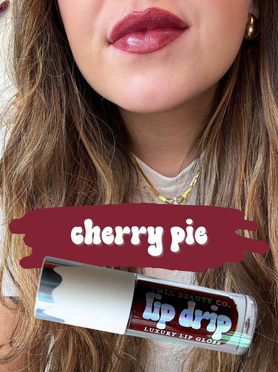 TMLL Beauty Co. Lip Drip Luxury Lip Gloss in Cherry Pie — a deep cherry red shade shown on lips with holographic tube below