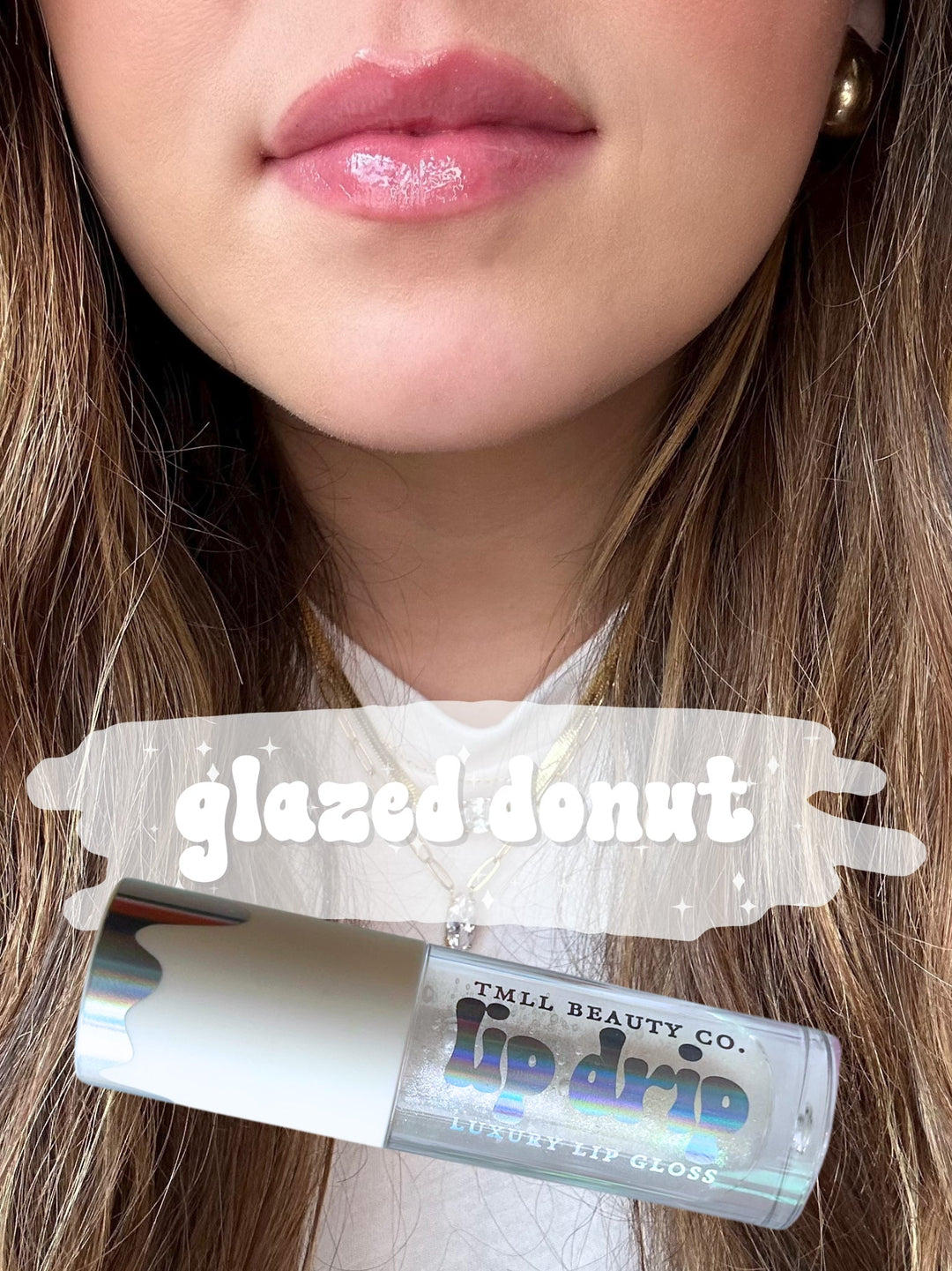 TMLL Beauty Co. Lip Drip Luxury Lip Gloss in Glazed Donut — a sheer glossy pink shade shown on lips with holographic tube below