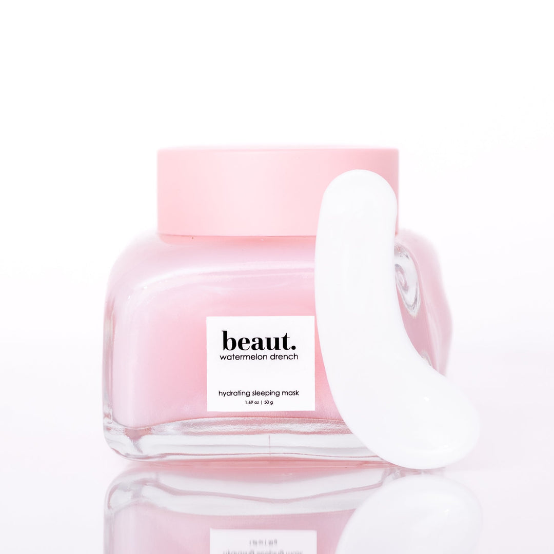 Beaut Watermelon Drench Hydrating Sleeping Mask 50g open glass jar with white spatula leaning against jar on white reflective surface