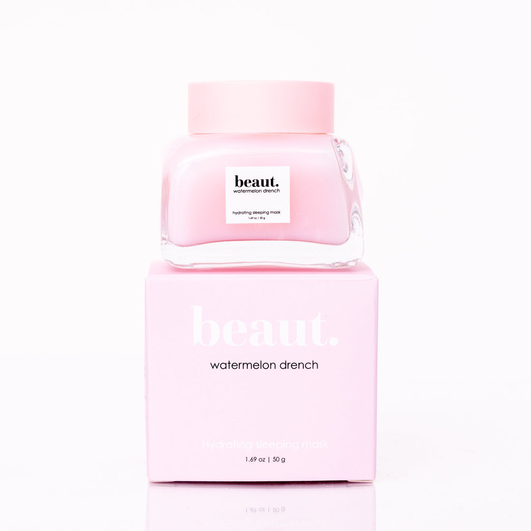 Beaut Watermelon Drench Hydrating Sleeping Mask 50g glass jar with pink lid stacked on top of pink retail box on white reflective surface
