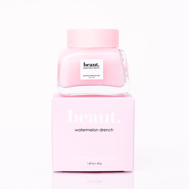 Beaut Watermelon Drench Hydrating Sleeping Mask 50g glass jar with pink lid stacked on top of pink retail box on white reflective surface