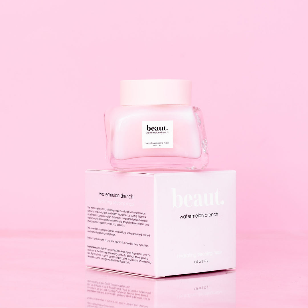 Beaut Watermelon Drench Hydrating Sleeping Mask 50g glass jar with pink lid stacked on top of pink retail box showing product description on pink reflective surface