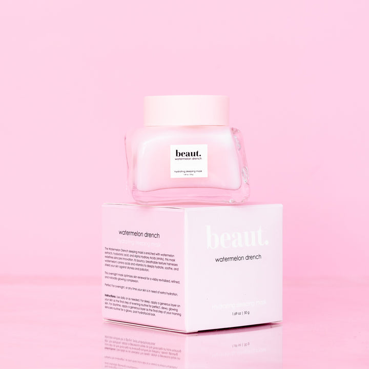 Beaut Watermelon Drench Hydrating Sleeping Mask 50g glass jar with pink lid stacked on top of pink retail box showing product description on pink reflective surface